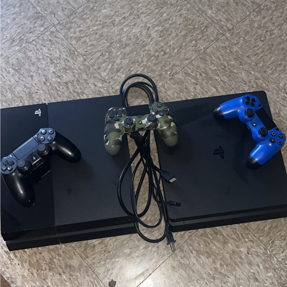 Sony PlayStation Console with Black Blue and Camouflage Controllers